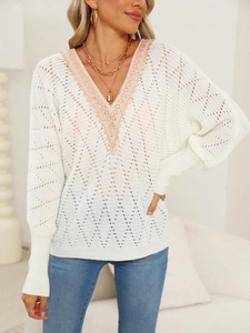 Close-up of white hollow-out knit sweater with delicate lace V-neck and wave textures