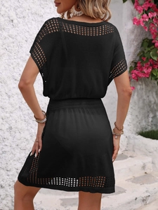 Back view of a black crochet beach cover-up dress featuring detailed openwork knit patterns