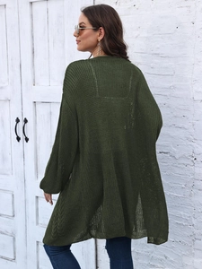 Detail of dark green knit cardigan featuring mesh hollow texture and lantern sleeves