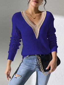 Detail of V-neck lace patchwork and diamond knit pattern on navy blue sweater