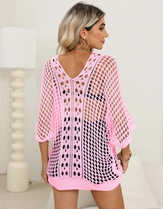 Detail of pink hollow out crochet cover up showing intricate mesh knit and V-neck back