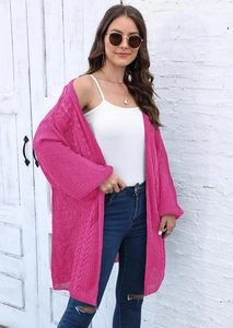 Detail of rose pink knit cardigan featuring crochet patterns and casual loose texture