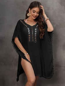 Bohemian black V-neck beach cover-up with crochet details and stylish pom-pom trim
