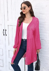 Detail of hot pink knit cardigan showing hollow out texture and loose lantern sleeves