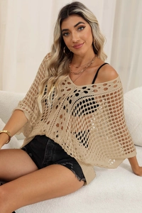 Detail of beige crochet knit cover-up showing intricate woven texture and batwing sleeves