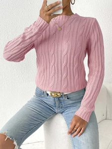 Detail of classic pink cable-knit sweater texture and round neckline for women
