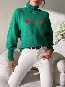Women's green high neck knit sweater with red heart embroidery and ribbed details
