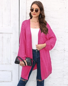 Detail of rose pink crochet knit cardigan showing hollow out floral patterns and cable knit