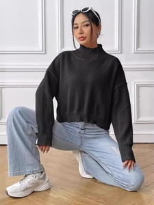 Women's black mock neck knit sweater in a loose casual fit with ribbed cuffs and hem