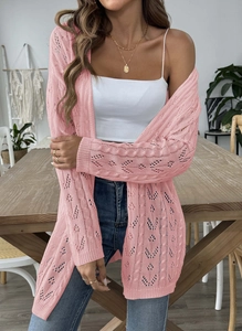 Close-up of pink openwork crochet knit cardigan showing texture and wavy pattern