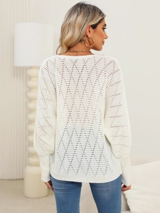 Detailed back view of a white hollow crochet sweater featuring V-shaped knit patterns