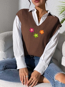 Détail du gilet en tricot marron à col en V avec trois ornements de fleurs au crochet en 3D