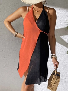 Detail of crochet knit beach dress featuring orange and black contrast stitching textures
