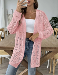 Detail shot of pink openwork knit cardigan showing long sleeves and soft woven texture