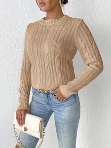 Close-up of cable knit texture and ribbed crewneck on light camel women sweater
