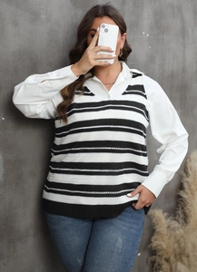 Detail of V-neck striped knit vest layered over a white long-sleeve shirt