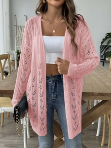 Detailed close-up of pink knit cardigan featuring hollow diamond patterns and crochet texture
