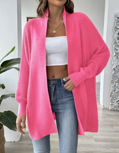 Detail of hot pink knit cardigan showing soft ribbed cuffs and thick premium fabric