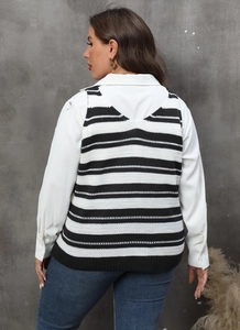 Detail of a women's striped knit vest layered over a white shirt with a V-neck back design
