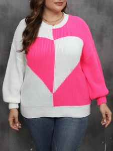Detail of plus size knitted sweater showing heart pattern and pink contrast color