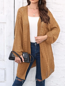 Detail of hollow-out knit cardigan with cable pattern in caramel color for women