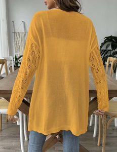 Detail of hollow-out crochet diamond pattern on the sleeve of this knit cardigan