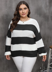 Macro detail of the soft texture and striped knit pattern on the oversized pullover sweater