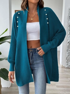 Detailed texture of peacock blue knit cardigan with white pearl beads and ribbed cuffs