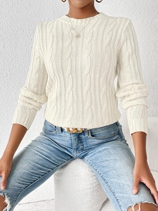 Detailed close-up of cable-knit texture on a white round-neck women's pullover sweater