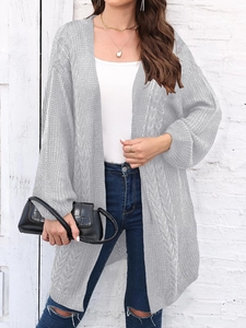 Detail of grey cable knit long cardigan with lantern sleeves and textured knit pattern