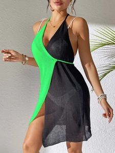 Detail of green and black split-color knit beach cover-up with high side slit