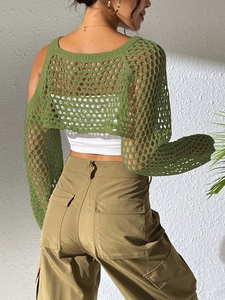 Detail of green crochet knit crop top with open mesh hollow out texture and long sleeves