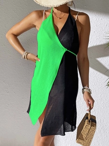 Detail of knit beach cover-up with contrast neon green and black wrap design