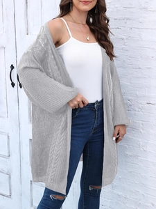 Close-up of grey knit cardigan featuring hollow-out patterns and cable knit texture