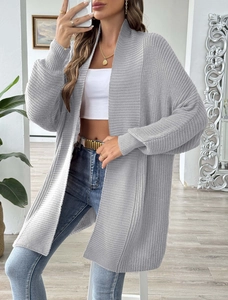 Detail of grey knitted long cardigan showing vertical stripe texture and ribbed cuffs