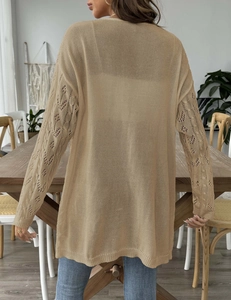 Detail of hollow-out diamond knit pattern on the sleeve of a khaki cardigan for women