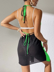 Close-up of sexy backless beach cover-up dress with green and black color block detail