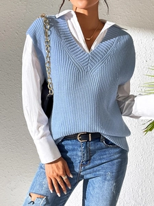 Detail shot of the V-neck knitted vest showing the light blue texture and layered look