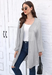 Detail shot of the chunky cable knit texture on a long grey open-front cardigan