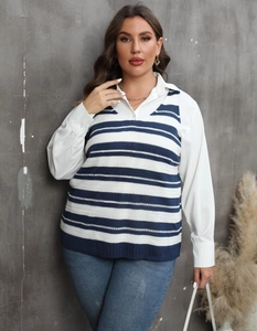 Detail of V-neck striped knit vest layered over a white shirt and blue jeans