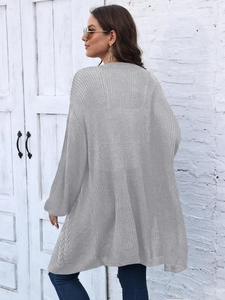 Detail shot of loose grey knit cardigan showing balloon sleeve texture and flowy design