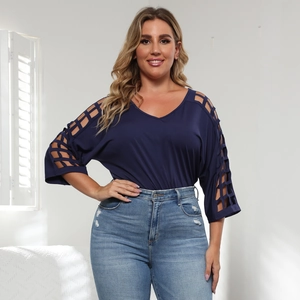 Detailed view of navy blue V-neck top featuring unique ladder cut-out sleeve embroidery