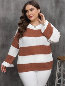 Detail of chunky knit texture on oversized striped pullover sweater in brown and white