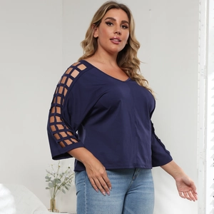 Detail of navy blue V-neck top showing unique lattice cut-out sleeves and smooth fabric texture