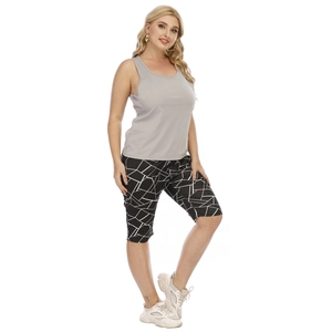 Detail of grey racerback yoga tank top and black geometric print cycling shorts set