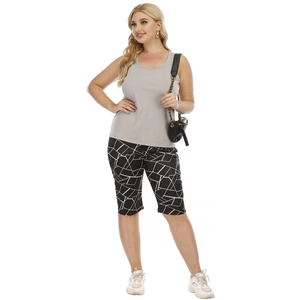 Detailed view of grey sleeveless racerback top paired with geometric print biker shorts