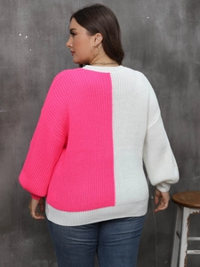 Detail view of the back of a loose knit sweater featuring pink and white color blocking