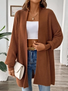 Close-up of caramel knit cardigan showing thick texture and relaxed long-line fit