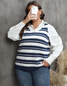 Detail of blue and white striped knit vest layered over a white long-sleeve shirt