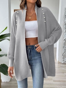 Detailed view of grey knit cardigan featuring elegant white pearl embellishments and ribbed cuffs